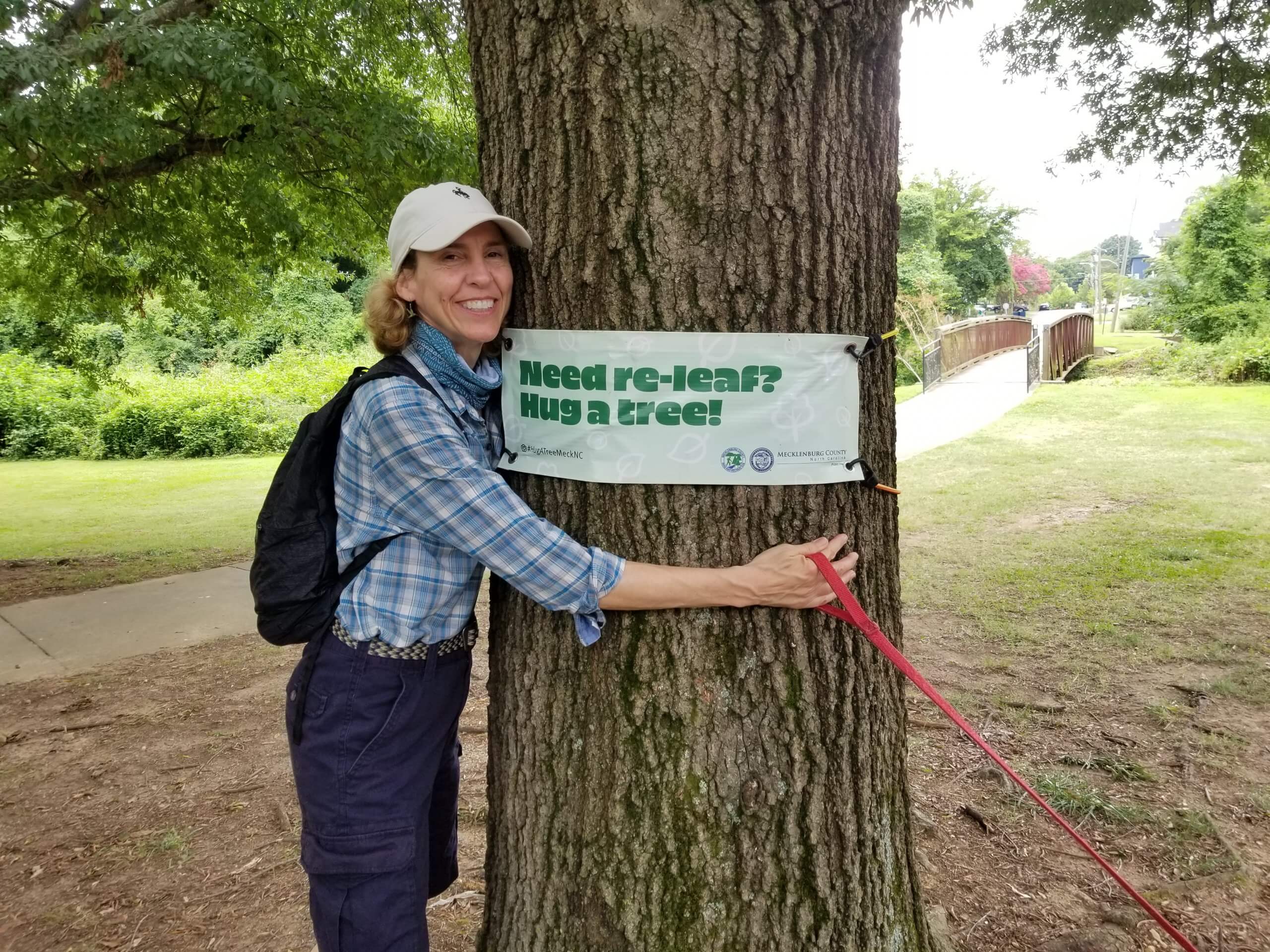 Jennifer Roberts hugs a tree and smiles in North Carolina