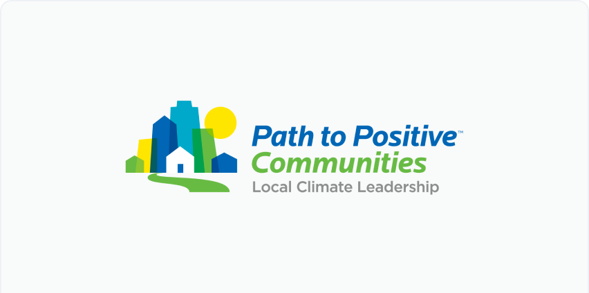 Path to Positve Communities logo. A blue, green, and yellow design of a cityscape next to text that reads "Path to Positive Communities Local Climate Leadership."