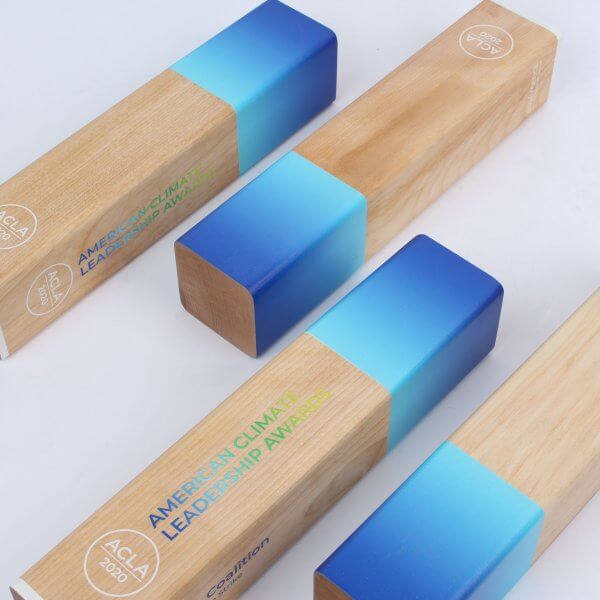 4 wood column awards painted with a blue gradient highlight